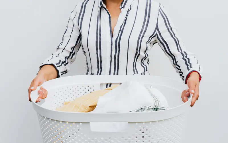 Woman holding a basket of laundry