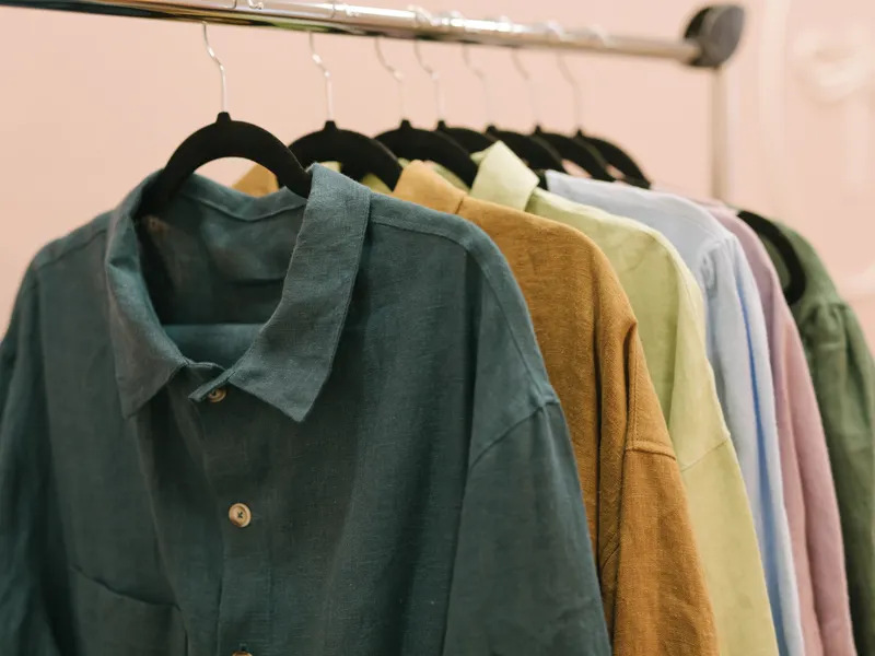 Shirts in earthy colours hanging on a clothes rail